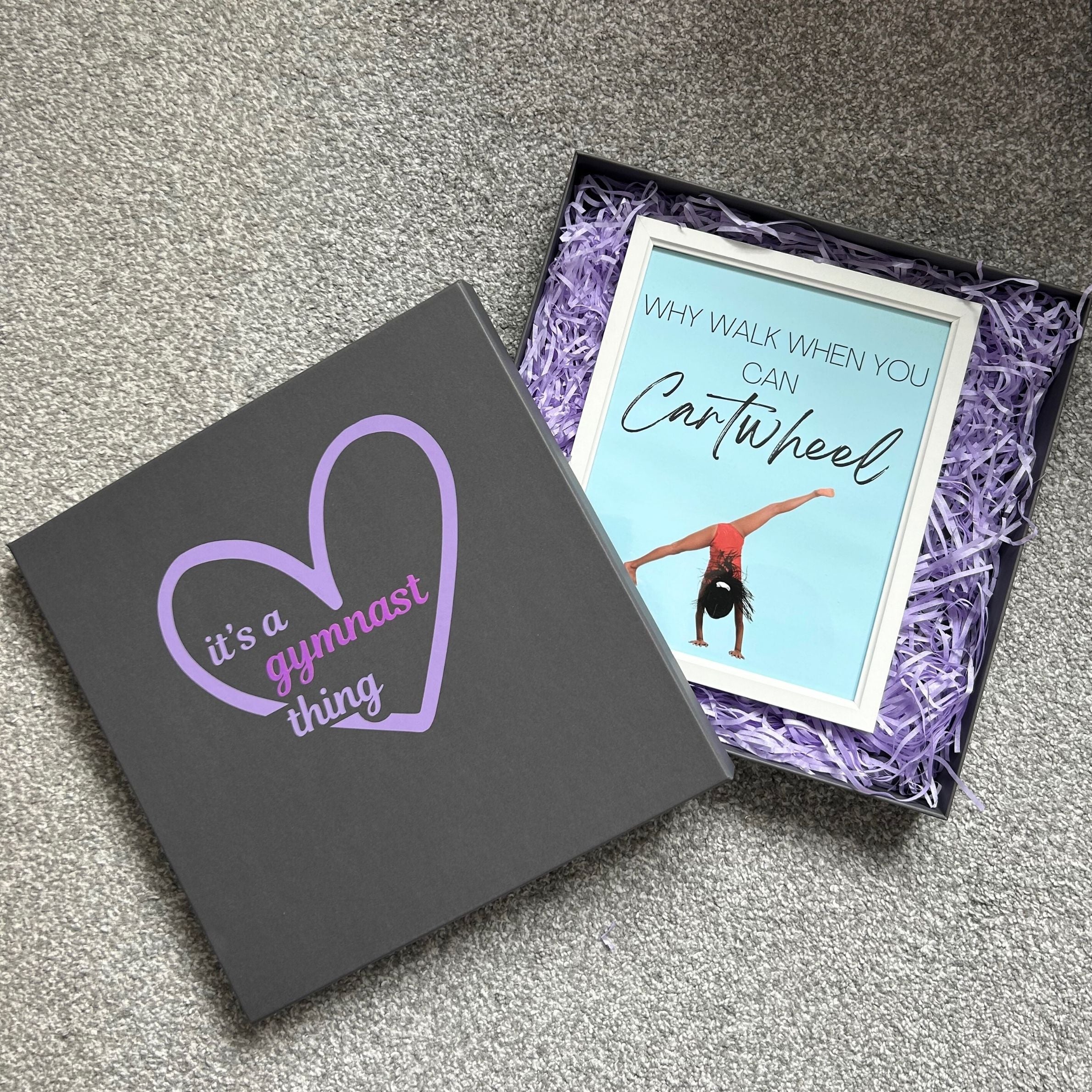 Gift box for gymnasts with a framed gymnastics print  inside featuring a gymnast with text 'why walk when you can cartwheel'