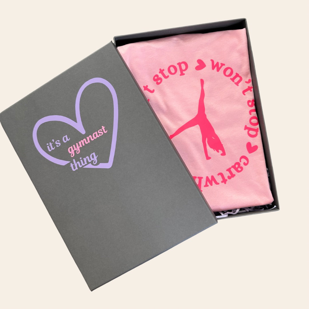 Gymnastics pink t-shirt in a grey gift box reading 'it's a gymnast thing' text and heart design.