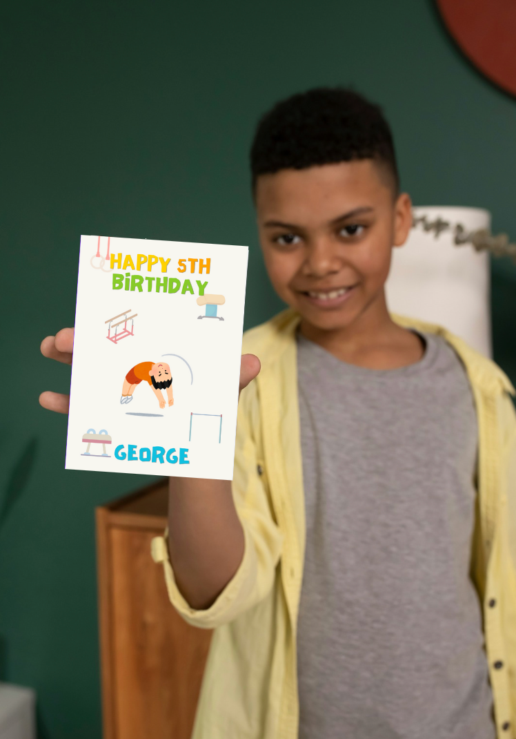 Boy holding a boys gymnastics birthday card with 'Happy 5th Birthday George' text