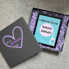 Open gymnastics gift box with a framed picture inside.
