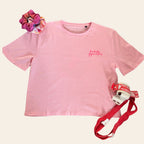 Pink gymnastics t-shirt with 'fantastic gymnastics' logo, scrunchie, handguards and loops on a cream background