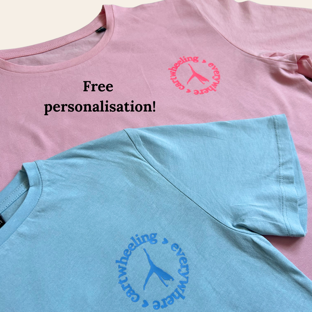 Pink and blue gymnastics t-shirts with cartwheeling everywhere design and text on a light background