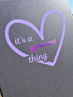 Grey certificate box for gymnasts with a purple heart-shaped design and text 'it's a gymnast thing'.