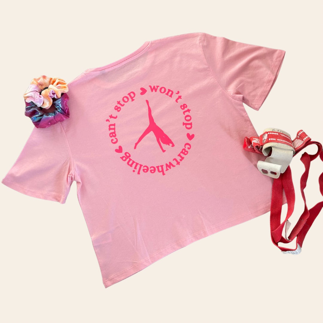 Pink cartwheel t-shirt with text and graphics, scrunchie, hand guards and loops on a cream background
