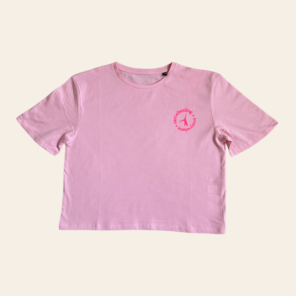 Pink t-shirt gift for gymnast with a cartwheel design on a beige background