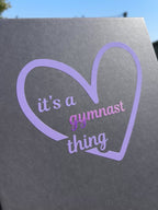 Lilac heart on grey gift box for gymnasts