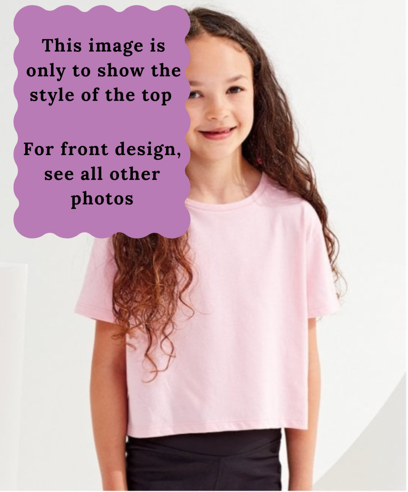 Young girl wearing a pink boxy t-shirt with a purple text box overlay.