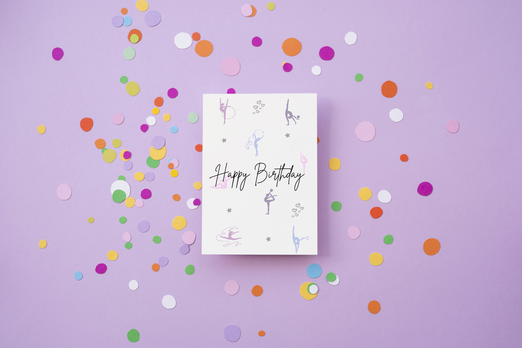 Ivory girls birthday card with 'Happy Birthday' and rhythmic gymnasts on a purple background with colorful confetti